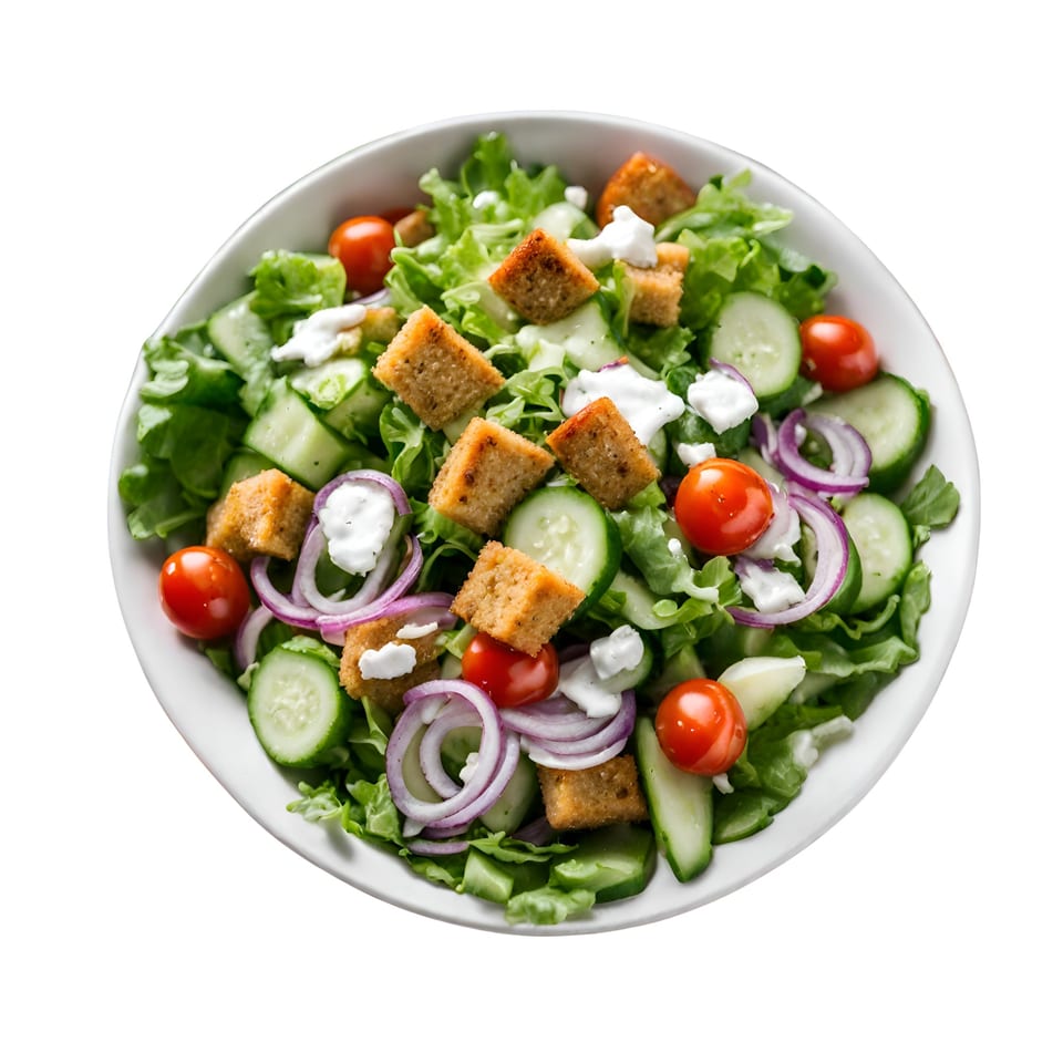 A Wedgies salad with lettuce, cucumbers, tomatoes, red onions, croutons, and dressing in a white bowl.